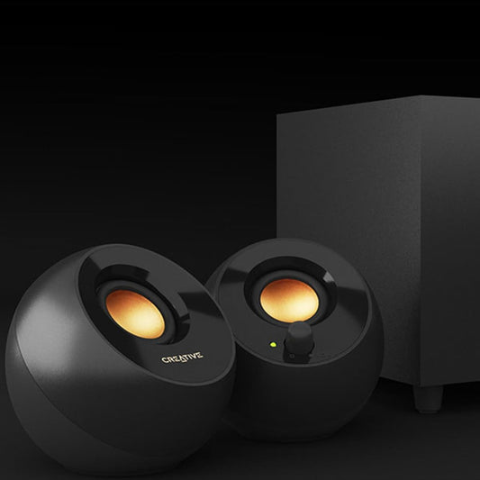 Black Creative pepper plus speakers with glowing lights on a dark background
