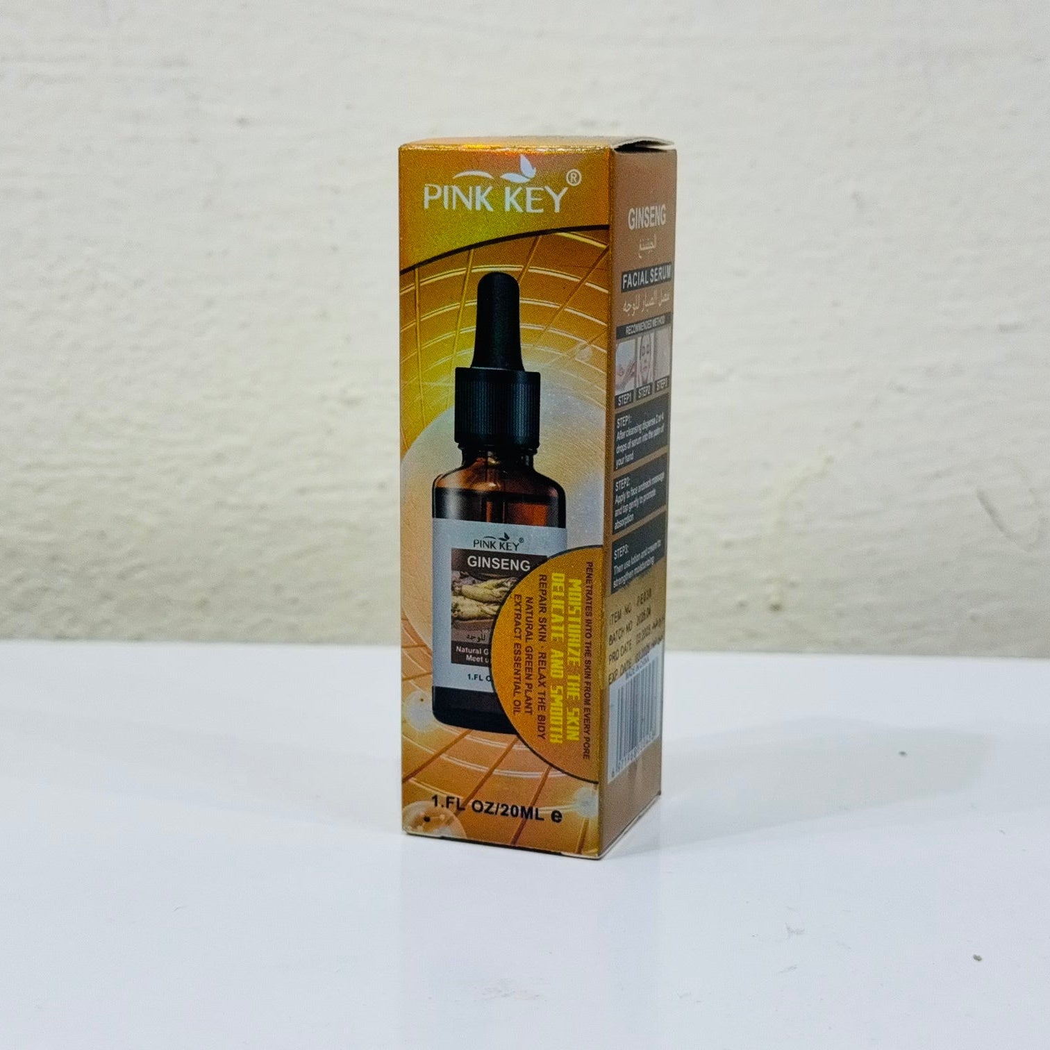 Pink Key bottle and box on a white background