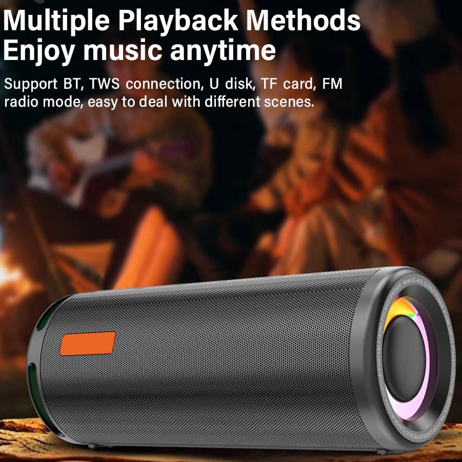 Portable speaker with text about playback methods on a blurred background of people around a campfire.