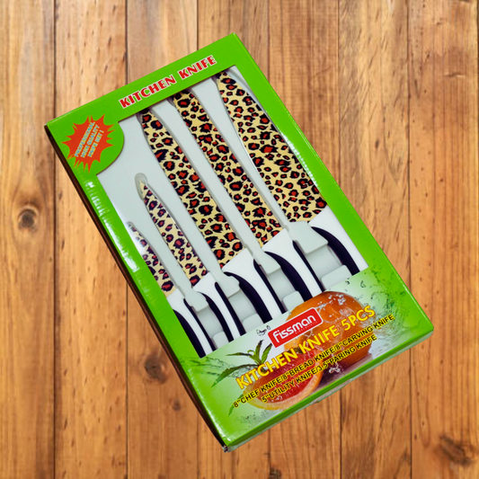 Set of kitchen knives with leopard print handles in a green box on a wooden surface