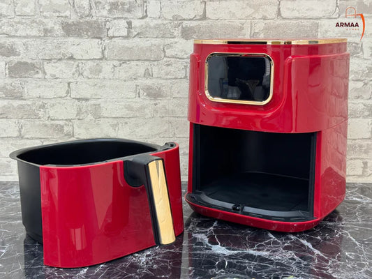 A red and black 8-liter air fryer with a capacity of 8 liters, shown with its lid open and beside it a smaller component, likely a drawer or tray, in a glossy finish.