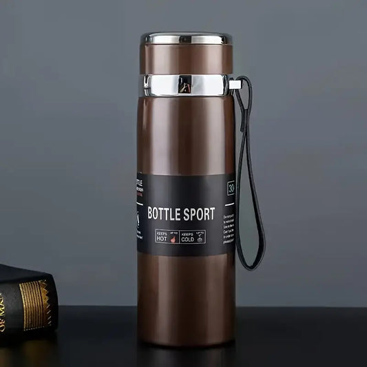 Brown insulated bottle with 'Bottle Sport' label on a dark surface and gray background
