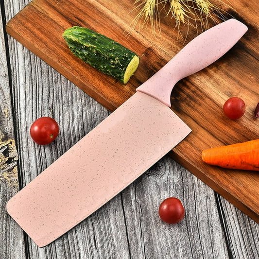 Pink knife with 'Buck-I' branding on a wooden cutting board with vegetables.
