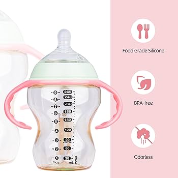 Baby bottle with pink handles on a pink background, featuring food-grade silicone, BPA-free, and odorless indicators.
