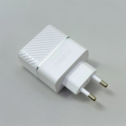 A white USB-C wall charger with a EU plug on a grey background.