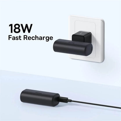 Baseus 18W fast charging device attached to a wall socket with clear background