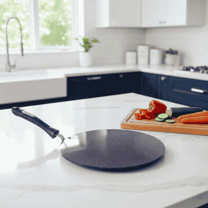 Black frying pan on a white kitchen counter with vegetables
