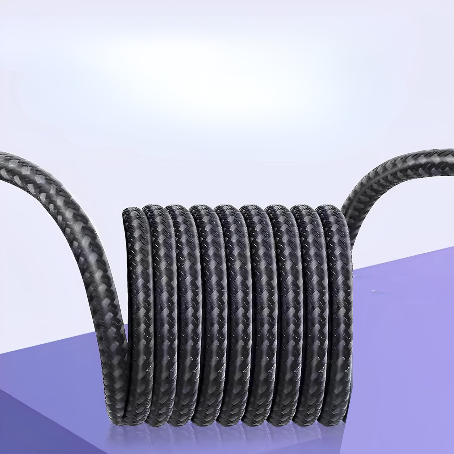 Coiled black cable on a light purple background