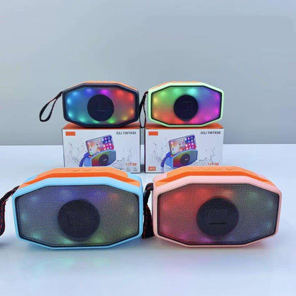 Colorful portable speakers with a box in the background on a light gray surface.