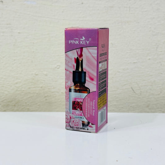 Pink Key essential oil bottle and packaging on a white surface with a light gray background
