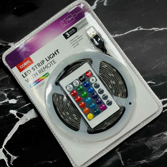 LED strip light with remote control on a black marble surface