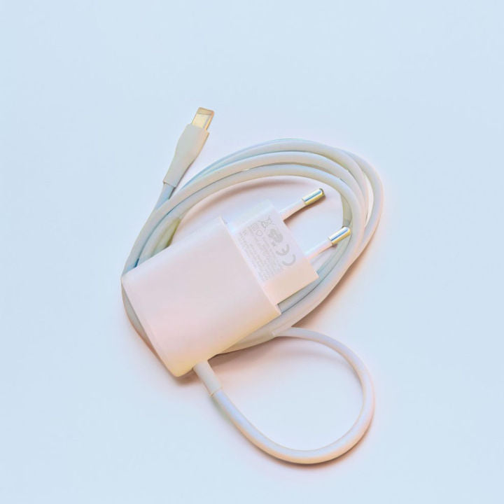 White electrical plug on a light blue background