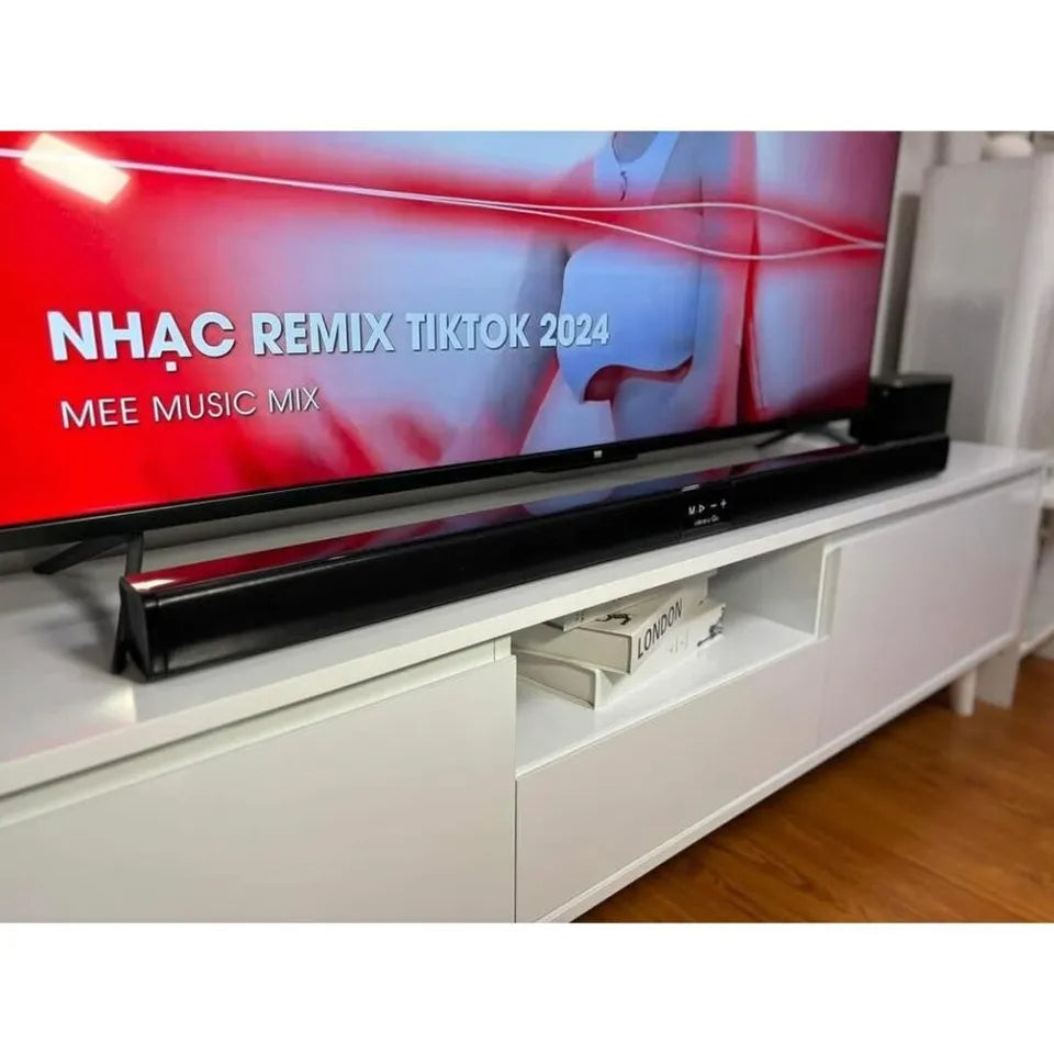 TV displaying 'NHAC REMIX TIKTOK 2024' on a white entertainment console.
