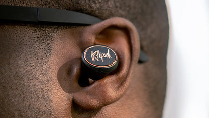 True wireless earbuds in an ear with Klipsch logo