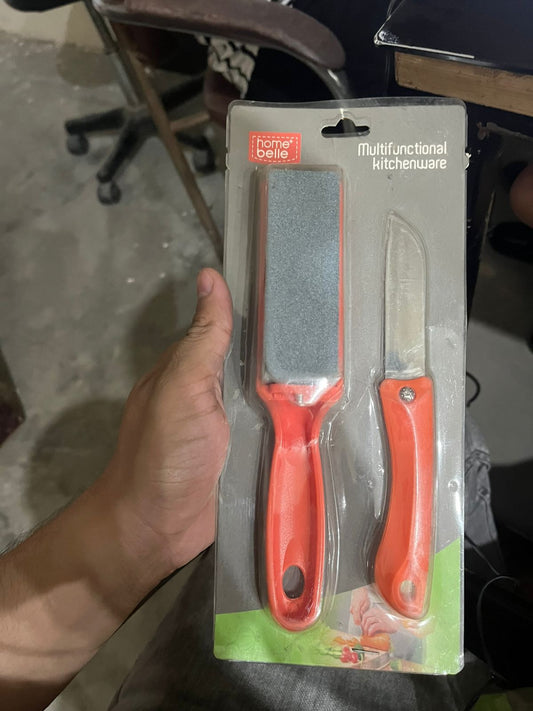 Two kitchen knives in packaging held by a person with a blurred background