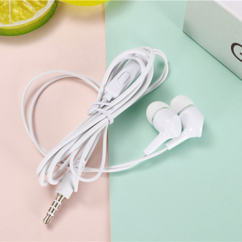 White earphones with a cable on a split pink and green background