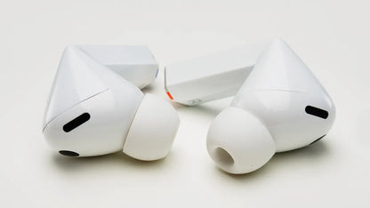 White wireless earbuds with charging case on a light gray background