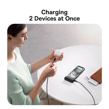 Woman using a baseus charging cable to charge two devices at once, with the brand logo visible.