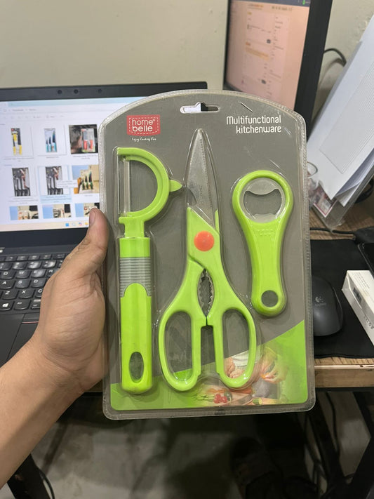 Set of green kitchen utensils including scissors, a knife, and a bottle opener on a gray background.