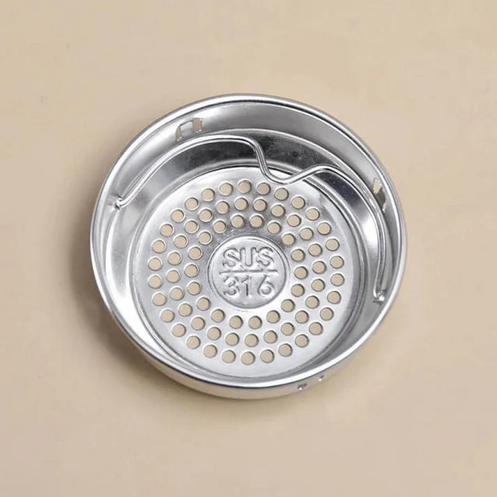 Stainless steel strainer with 'SUS 316' marking on a beige background
