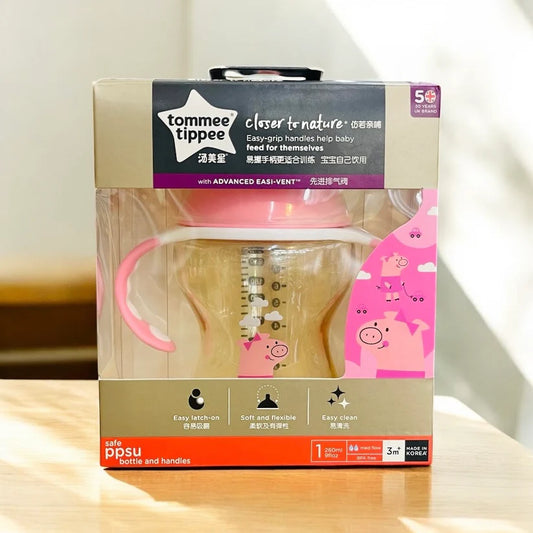 Tommee Tippee baby bottle packaging with pink design on a light background